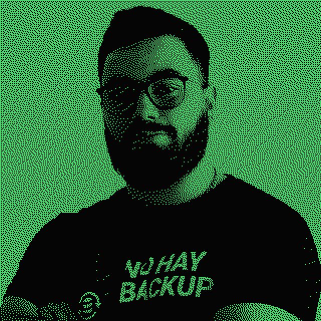Juan Bulla, dithered to two tones, arms crossed, black t-shirt reading NO HAY BACKUP